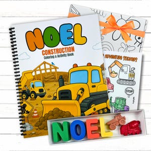 A deluxe childrens construction bundle set showcasing a bulldozer cover workbook, custom name crayons spelling NOEL, custom stickers, and an orange ribbon box.