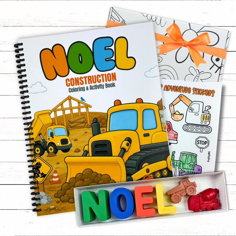 A deluxe childrens construction bundle set showcasing a bulldozer cover workbook, custom name crayons spelling NOEL, custom stickers, and an orange ribbon box.