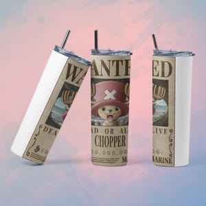 May include: Three stainless steel tumblers with straws, featuring a "Wanted" poster design. The posters display a cartoon character with a pink hat and the name "Chopper". The tumblers have a white background and a silver straw.