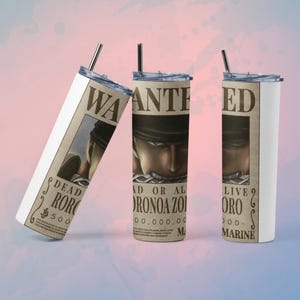 May include: Three stainless steel tumblers with lids and straws. Each tumbler features a "Wanted" poster design with the text "DEAD RORONOA ZORO" and "AD OR AL ORONOA ZOI". The background is a gradient of pink and blue.