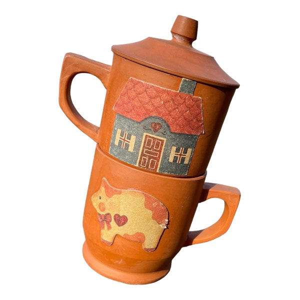 Two Vintage, Red Clay Terracotta Mugs, One with a Lid and both Decorated in a Folk Art Pig, Cat and a Cozy Home, Artwork