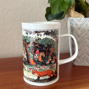 May include: A set of three ceramic mugs with a speckled, matte finish. The mugs are in shades of cream, light gray, and dark gray. Each mug has a simple, minimalist design and a rounded handle.