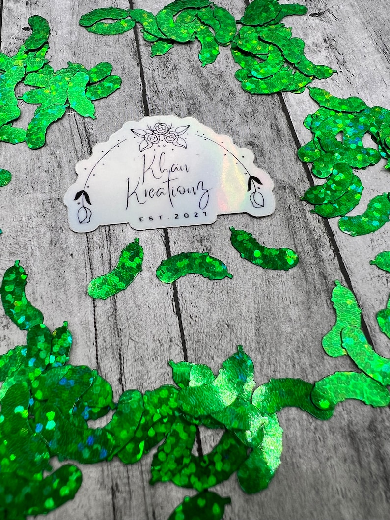 May include: Green glitter sticker with the text "Khan Kreations EST. 2021" surrounded by green glitter confetti.