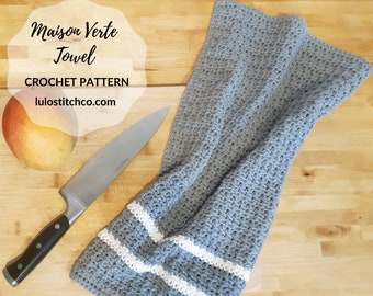May include: A gray crochet kitchen towel with white stripes. The towel is folded and lying on a wooden surface. The text "Maison Verte Towel" and "CROCHET PATTERN" is visible in the image.