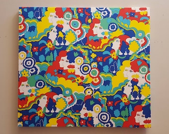 May include: A colorful abstract painting featuring a repeating pattern of stylized faces, flowers, and swirls in shades of blue, yellow, red, and green.