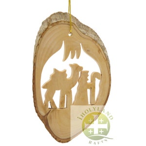 May include: A wooden Christmas ornament featuring a cutout design of the three wise men and a camel. The ornament is made from a slice of wood with a natural bark edge and a gold string for hanging.