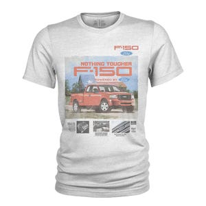 May include: A light gray t-shirt featuring a vintage-style graphic of a red Ford F-150 pickup truck. The graphic includes the text "F-150 Ford" and "Nothing Tougher". Additional small images and text are below the truck.