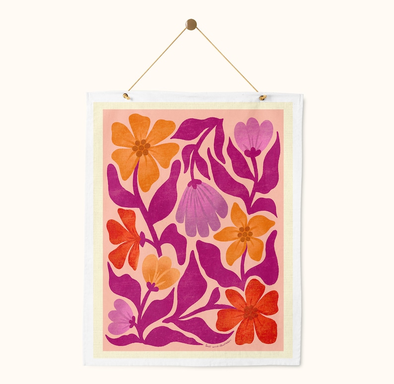 May include: A pink and orange floral print wall hanging with a white border. The flowers are stylized and have a retro feel.
