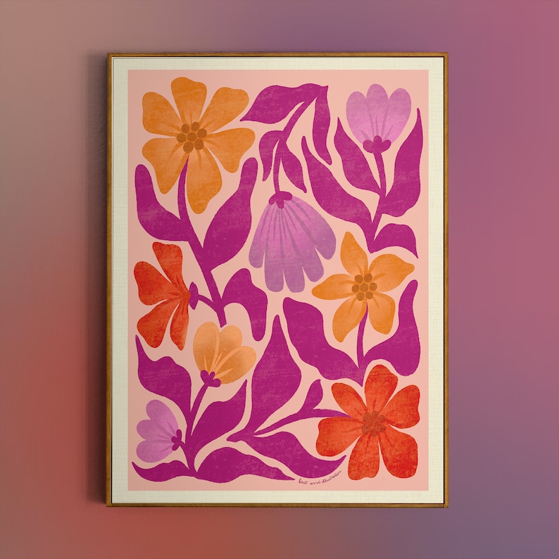 May include: A pink and orange floral print with a pink background. The flowers are stylized and have a retro feel. The print is framed in a light wood frame.