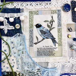 May include: A collage featuring various blue and white fabrics, lace, and embellishments. A central image depicts a blue bird on a branch with text. Decorative buttons, ribbons, and floral patterns add texture and visual interest to the artwork.
