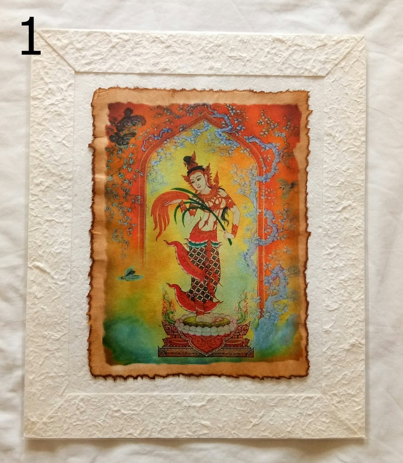 May include: A framed print of a colorful painting depicting a woman in a red and gold dress standing on a platform. The woman is holding a branch with leaves and flowers. The background is a vibrant orange and yellow with a blue and green archway.