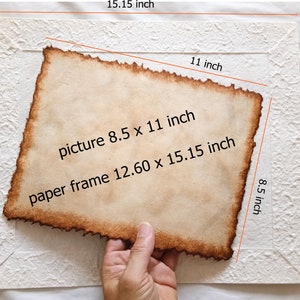 May include: A white textured paper frame with a brown paper picture inside. The frame measures 12.60 inches by 15.15 inches and the picture measures 8.5 inches by 11 inches.
