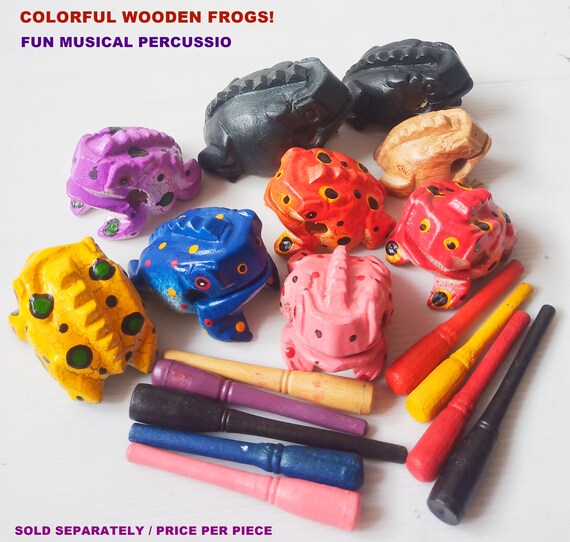 A hand-painted wooden frog that actually croaks when you drag a stick across its ridged back — a tactile, musical desk toy with genuine handmade character.