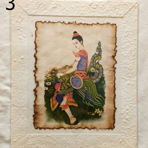 May include: A framed painting of a woman in a colorful dress sitting on a peacock. The painting is on a textured paper background.