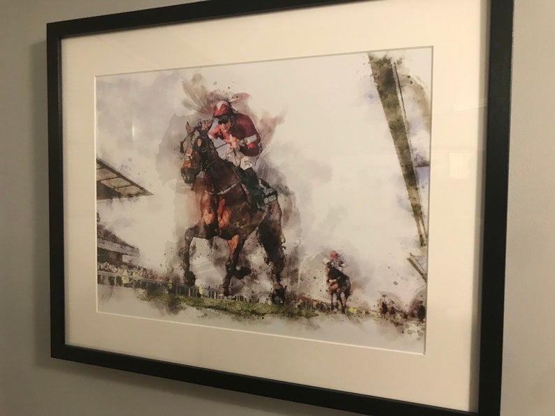 May include: A watercolor painting of a jockey riding a brown horse in a race. The jockey is wearing a red and white uniform and a helmet. The horse is running at full speed, with its legs outstretched. The background is a blurred image of a racetrack.