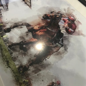 May include: A watercolor painting of a horse and rider jumping over a fence. The horse is brown and the rider is wearing a red and white uniform. The background is a blurry watercolor wash of green and white.