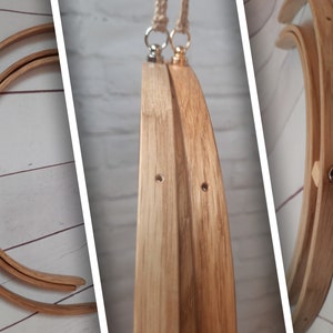 May include: Three wooden embroidery hoops with a natural finish. The hoops are nested together and have a metal ring at the top for hanging. The hoops are made of bamboo and have a smooth surface.