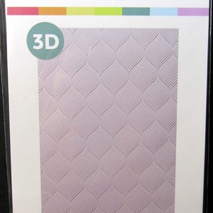 May include: A Scrapbook.com 3D embossing folder labeled Ethereal. The packaging features a light purple background with a repeating wave pattern. The text reads 3D EMBOSSING FOLDER and 1 Folder 5.5 x 8.5in ETHEREAL.