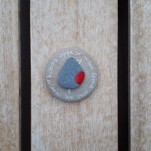 May include: A round stone with a painted robin and the text "Robins appear when loved ones are near".