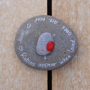 May include: A gray stone painted with a robin, a heart, and the text "When Robins appear, ones we loved are near".