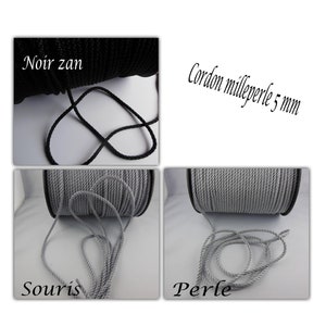 May include: Two spools of cord, one black and one grey. The black cord is labelled "Noir zan" and the grey cord is labelled "Souris". The grey cord is also labelled "Cordon milleperle 5 mm" and "Perle".