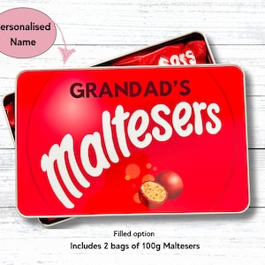 May include: Red and white tin with the text "GRANDAD'S Maltesers" on the front. The tin is filled with two bags of 100g Maltesers.