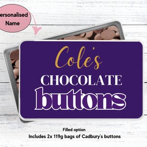 May include: A purple metal tin with a white label that says "Cole's Chocolate buttons". The label has gold lettering. The tin is filled with chocolate buttons.