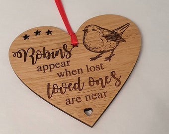Robins appear when lost loved ones are near, heart shaped wooden Christmas tree decorations.