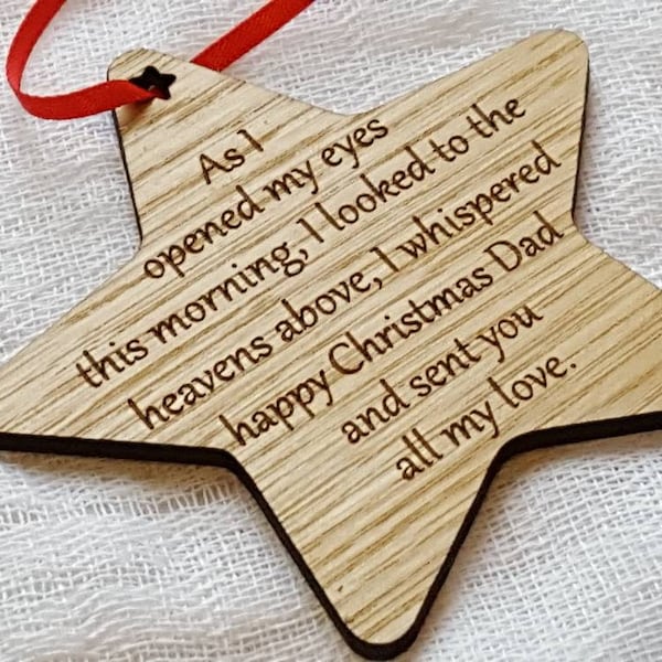 Wooden Christmas tree decorations with words to remember loved ones at Christmas.