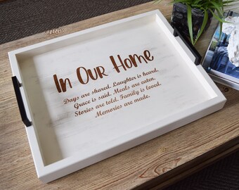 May include: White wooden serving tray with black handles. The tray has a brown inscription that reads "In Our Home Days are shared. Laughter is heard. Grace is said. Meals are eaten. Stories are told. Family is loved. Memories are made."