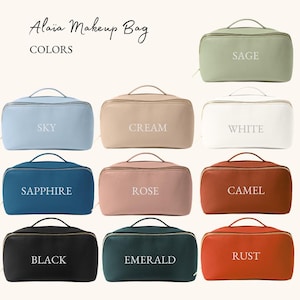 May include: A set of 10 makeup bags in various colors, including sage, white, sky, cream, sapphire, rose, camel, black, emerald, and rust. Each bag has a zipper closure and a white text label with the color name.