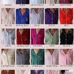 May include: A chart displaying 20 different colours of pyjamas with a white trim. The colours include white, navy, dusty blue, ecru, deep wine, blush, royal blue, lilac, plum, red, grey, burgundy, sangria, sage, black, champagne, charcoal, emerald, baby pink, dusty pink, burnt red, beige stripes, true navy, coral berry, and grey stripes.