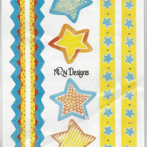 May include: Sheet of decorative stickers featuring star and zigzag designs. The stars are yellow, orange, and blue with various patterns. The zigzag borders are blue, yellow, and red. The text "NRN Designs" is visible.