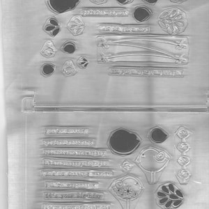 May include: Clear plastic sheet with various rubber stamps featuring small birds, flowers, and text. The text includes phrases like "you're moving", "you're retiring", "you have a new baby", "I'm so happy for you", "you're getting married", "you're expecting", "it's your birthday", "it's your special day", "congratulations", and "you're under the weather".