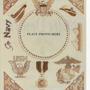 May include: A brown and white scrapbook page with a circular frame for a photo. The frame is decorated with a rope border and the words "PLACE PHOTO HERE". The page also features various military-themed images, including an eagle, a ship, and a sailor's hat. The text "Go Navy" is written in a decorative font in the upper left corner. The text "USN" is written in a decorative font in the lower left corner. The text "NRN Designs" is written in the lower left corner. The text "S1068" is written in the lower center. The text "ACID FREE" is written in the lower right corner.