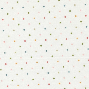 May include: Off-white fabric with a repeating pattern of small, evenly spaced polka dots. The dots are in various colors, including pink, green, blue, and yellow. The fabric appears to be cotton or a similar material.