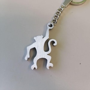 Hanging monkey, flying monkey, orangutan keyring, aluminum hominid