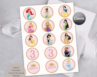May include: A digital printable sheet featuring fifteen circular cupcake toppers with pink glitter-style borders. The designs include various animated princesses, the number 3 in pink, and the name KENZIE with a gold crown graphic above it.