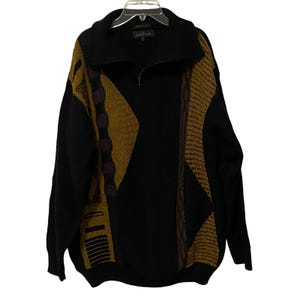 May include: A black long-sleeve quarter-zip sweater featuring a textured, abstract pattern in shades of mustard yellow, dark brown, and purple. The garment has a high collar, a central zipper closure, and ribbed cuffs and hem, with the label Imatchi.