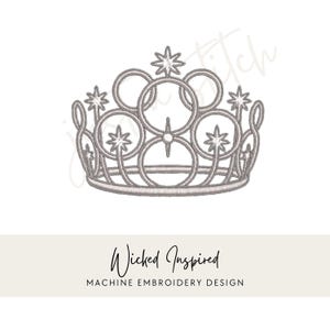 May include: A silver-colored crown design with star accents, featuring a series of interconnected circles and star-shaped embellishments. The text "Wicked Inspired" and "MACHINE EMBROIDERY DESIGN" are displayed below the crown.