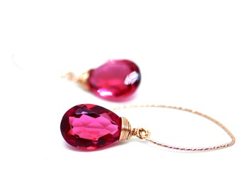 May include: A pair of pink gemstone earrings with rose gold wire wrapped around the stones and a delicate rose gold chain.