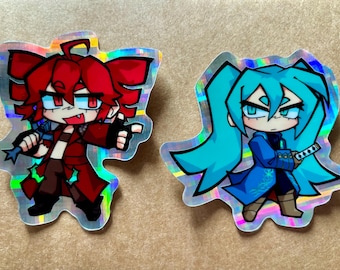 May include: Two holographic stickers featuring anime-style characters. The first sticker is red and features a character with red hair and a red jacket. The second sticker is blue and features a character with blue hair and a blue jacket.