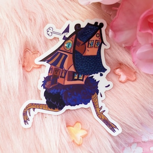 May include: A whimsical sticker featuring a cartoon house with a chimney, windows, and a striped roof, perched atop a cartoon chicken with blue feathers and long legs.