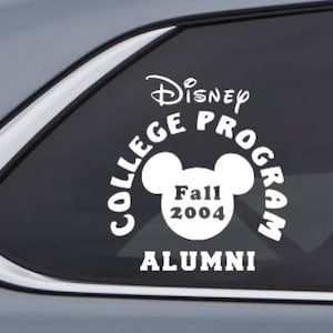 May include: White vinyl sticker with the text "Disney College Program Alumni" and a Mickey Mouse head with the text "Fall 2004" inside.