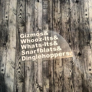 May include: White text on a woodgrain background reads "Gizmos & Whooz-Its & Whats-Its & Snarfblat & Dinglehoppers."