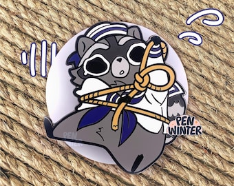 May include: A gray raccoon wearing a blue and white sailor hat and a white shirt is tied up with a yellow rope. The raccoon is looking up with a surprised expression. The text "PEN WINTER" is in the lower right corner of the image.