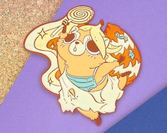May include: A yellow and orange enamel pin featuring a cartoon raccoon holding a lollipop. The raccoon is wearing a blue and white striped swimsuit and a white dress. The pin has a sparkly background and the text "PEN WINTER" is visible in the bottom right corner.