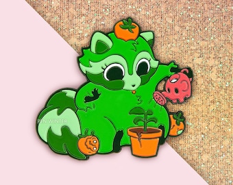 May include: Green raccoon enamel pin with a red watering can, a potted plant, and a small orange fruit. The pin says "PEN WINTER" on the tail.