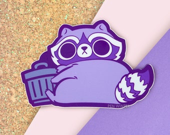 May include: Purple raccoon sticker with a trash can. The raccoon is holding the trash can with its left paw and has a white stripe on its tail. The sticker has the text "PEN WINTER" at the bottom.