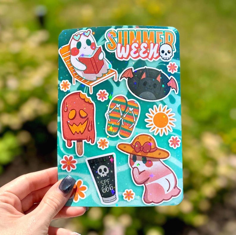 May include: A teal sticker sheet with various summer-themed illustrations. Includes a ghost reading a book, a bat, a popsicle, flip-flops, a sun, a ghost wearing a hat, and a tube of SPF 666. The words "SUMMER WEEK" are also present.
